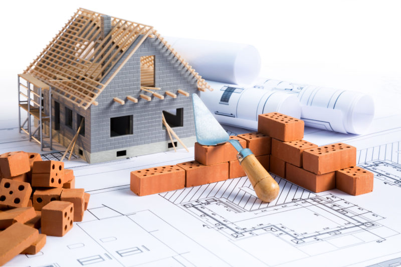 41378319 - house in construction project with brick and blueprint