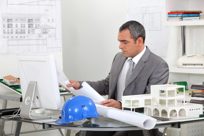 Architect Looking At Plans