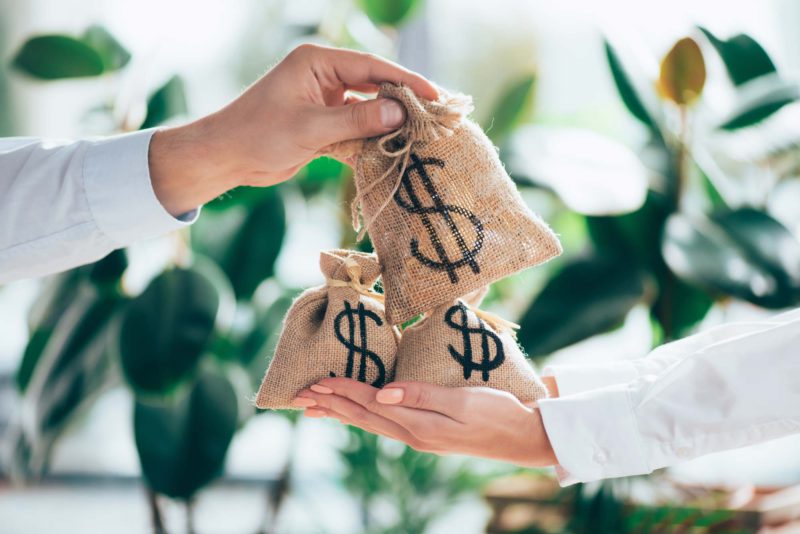 Partial View Of People Holding Sackcloth Bag With